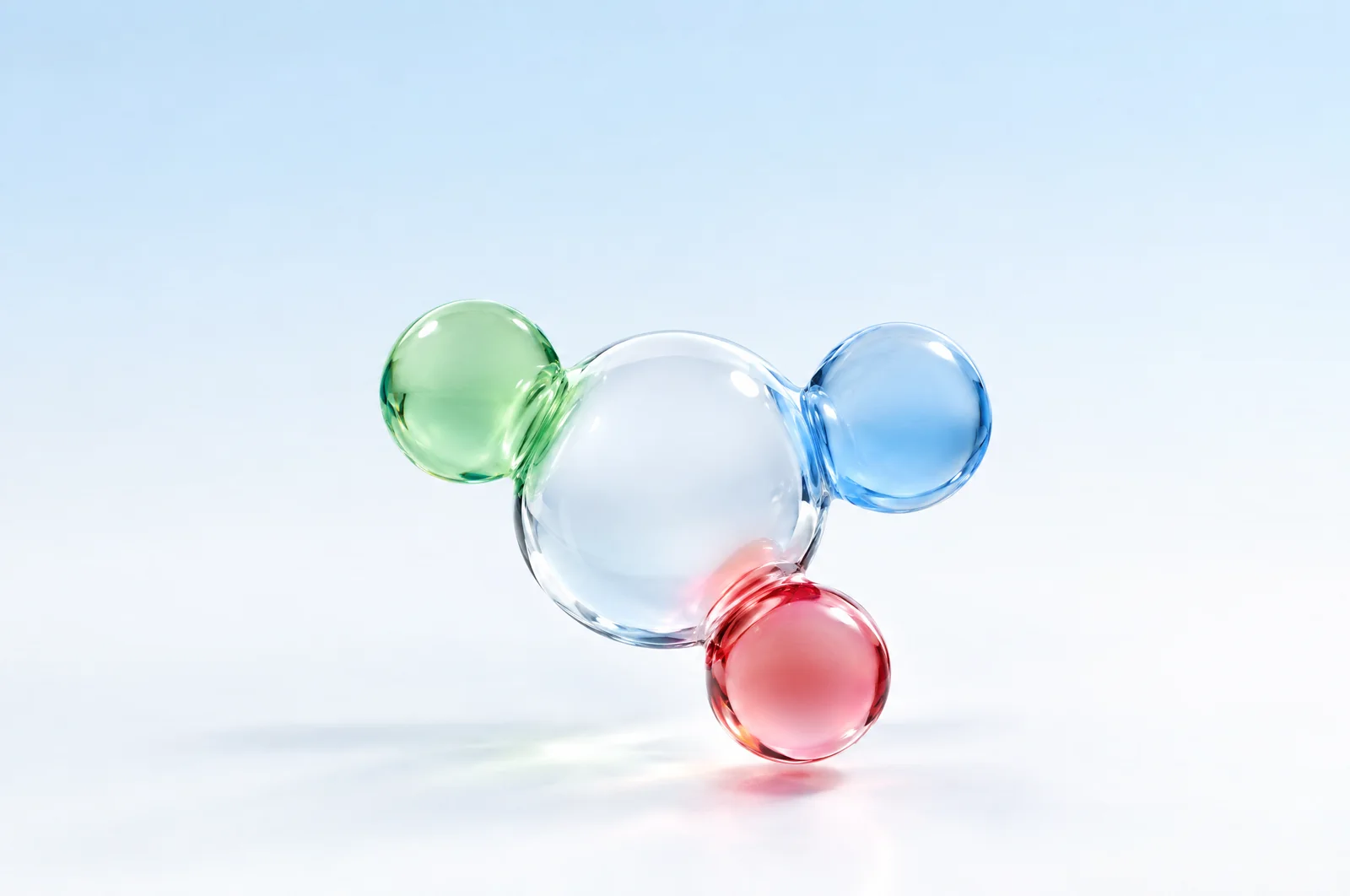 Glass spheres connected by light on a pale blue surface