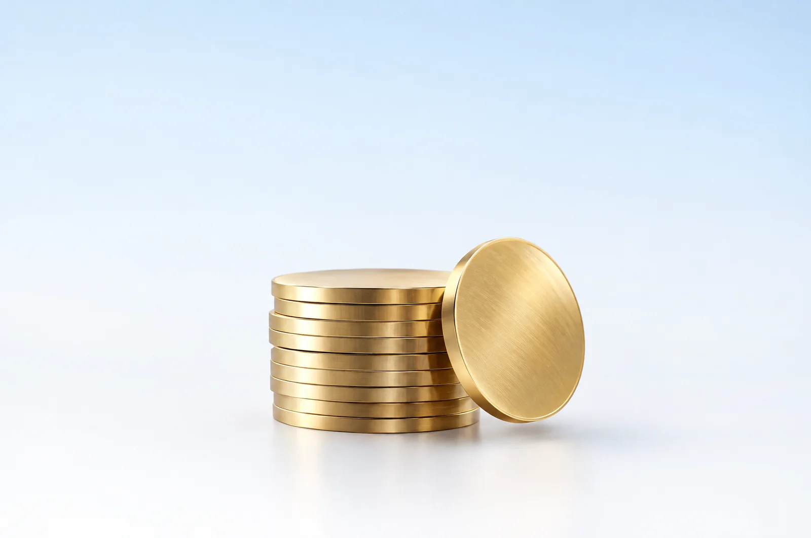 Glass coins stacked on a pale blue surface