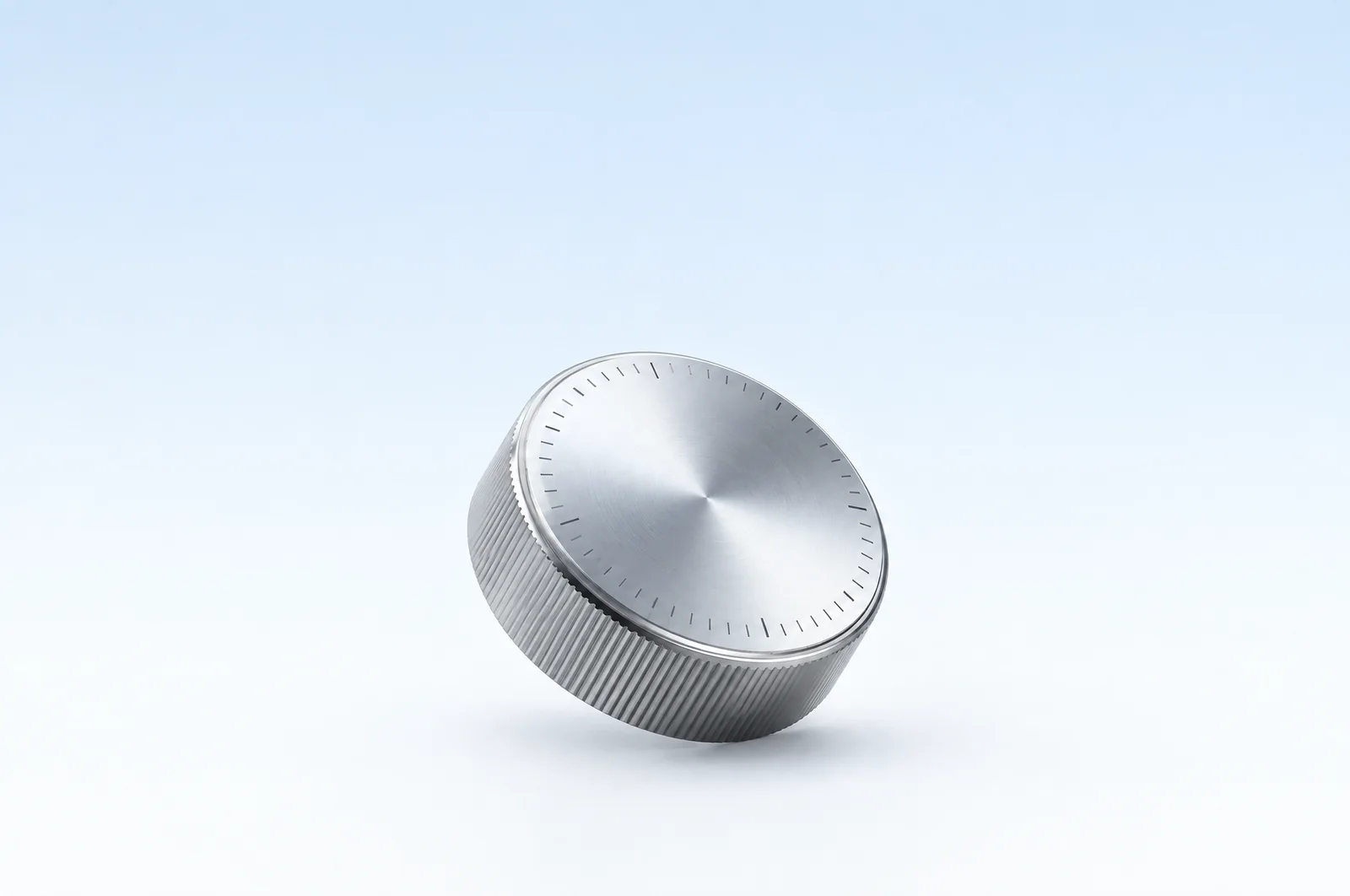 A glass dial on a pale blue surface